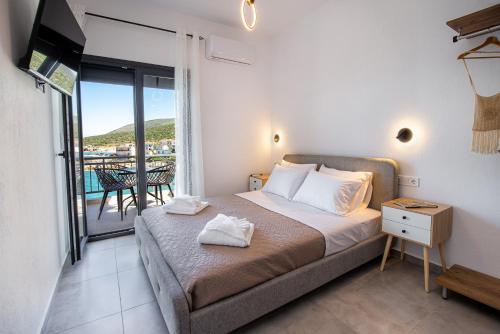 a bedroom with a bed and a balcony at Sea U in Kalívia