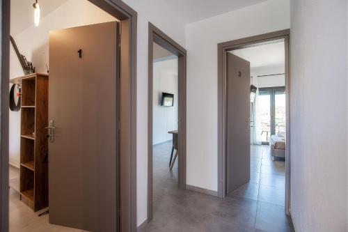 a hallway with a door leading to a living room at Sea U in Kalívia