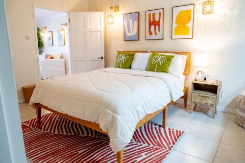 a bedroom with a large bed with green pillows at Golden View Unit 204 in Saint James