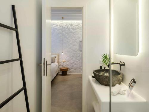 a bathroom with a sink and a bath tub at Plateia House Mykonos in Mikonos