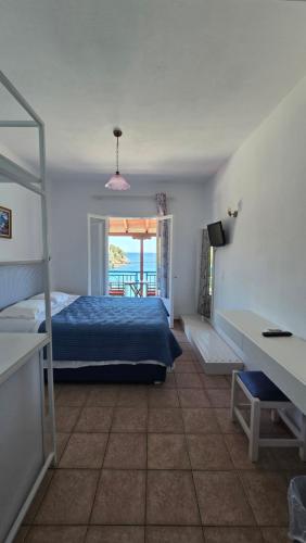 ein Schlafzimmer mit Bett und Meerblick in der Unterkunft Nostos in Patitiri