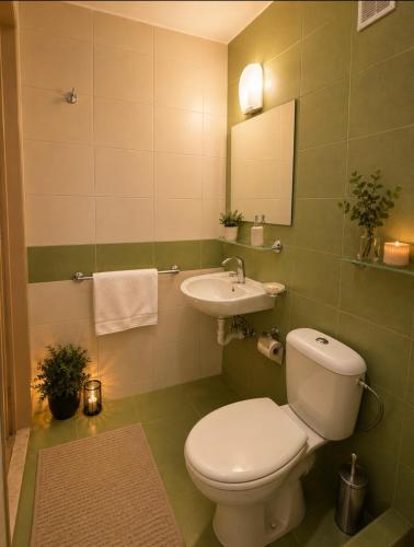 a bathroom with a toilet and a sink at Hotel Olimpiya in Balchik