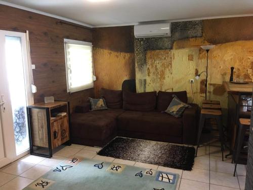 a living room with a couch and a table at Lena Lodge in Fonyód