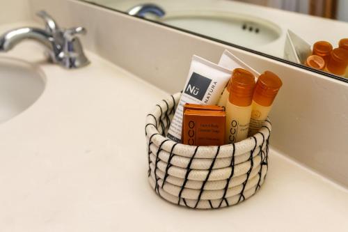 a basket on a bathroom counter with toiletries at Fidalgo Country Inn in Anacortes