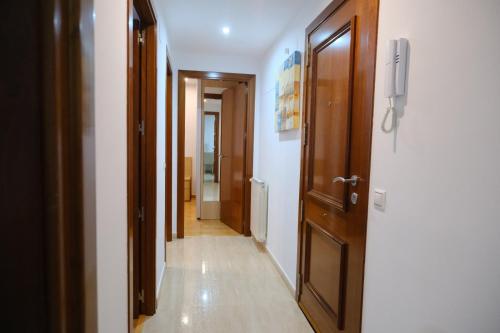 a corridor of a hallway with two doors and a hallway at Apartament Esmolet in La Pobla de Segur