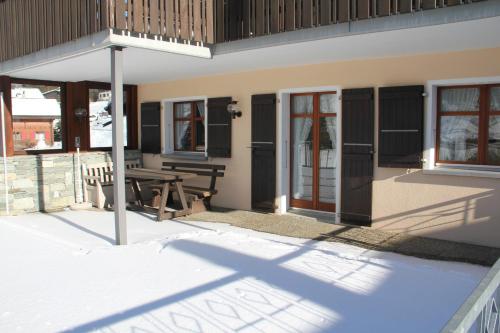 a patio with a picnic table and a building at Chalet Bettlihorn in Ernen