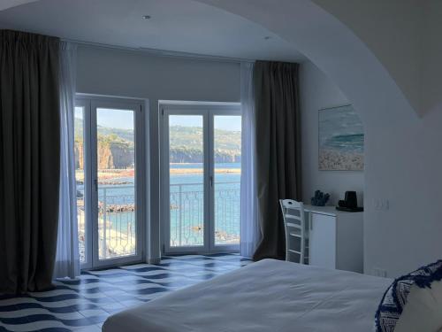 a bedroom with a bed and a view of the water at Metasuites Beach in Meta