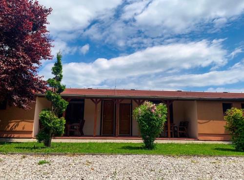 a house with two trees in front of it at Apartmány Harmónia in Veľký Meder