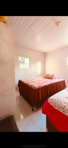a bedroom with two beds and a window at Casa de veraneio jacuma in Conde