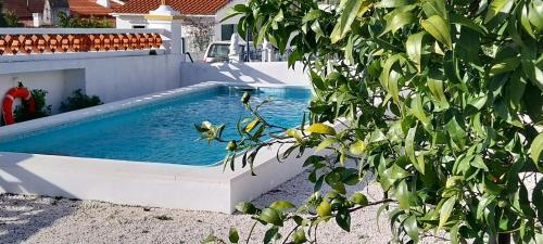 a swimming pool sitting next to a house at Cantinho de Terena - Cheiros Da Terra in Terena