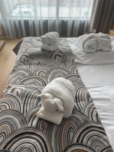 a couple of beds with towels on top of them at Apartament u Bartosów in Czarny Dunajec