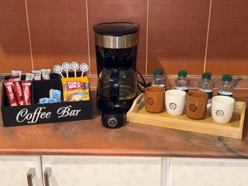 a coffee bar with cups and a coffee maker on a counter at دور سياحي in Abha