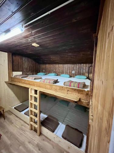 a large bunk bed in a wooden room at Bergunterkunft Ova Spin in Zernez