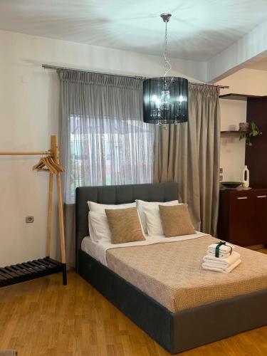 a bedroom with a large bed in front of a window at Angel's Luxury Studio in Olympiada