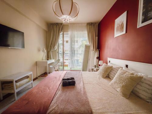 a bedroom with a large bed and a large window at Glow Central Apartment Eminescu in Târgu-Mureş