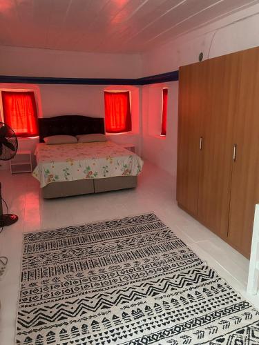 a bedroom with a bed and a rug and red lights at DaSH EV in Bodrum City