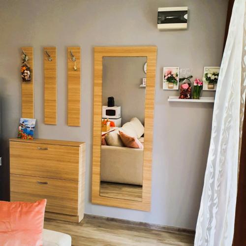 a bedroom with a mirror and a bed in it at Студио Стайл - Соренто Соле Маре in Sveti Vlas
