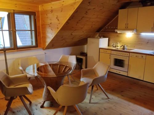 a kitchen with a table and chairs in a room at Golden Serafín - Romantic apartment below Karlštejn in Karlštejn
