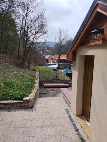 a walkway next to a building with a door at Golden Serafín - Romantic apartment below Karlštejn in Karlštejn