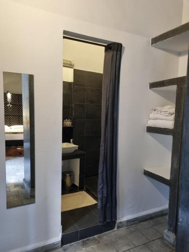 a bathroom with a shower and a mirror at Riad7 in Azemmour