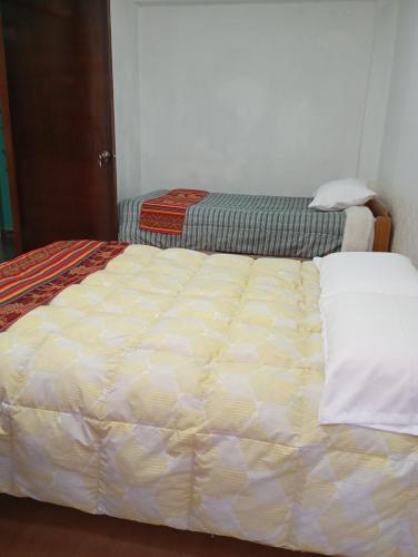 a bed in a room with a mattressvisor at APARTAMENTO Acogedor cerca del aeropuerto Cusco in Cusco