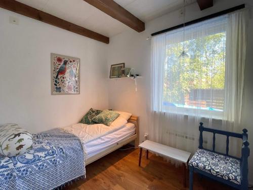 a small bedroom with a bed and a window at 7 person holiday home in Mönsterås in Mönsterås