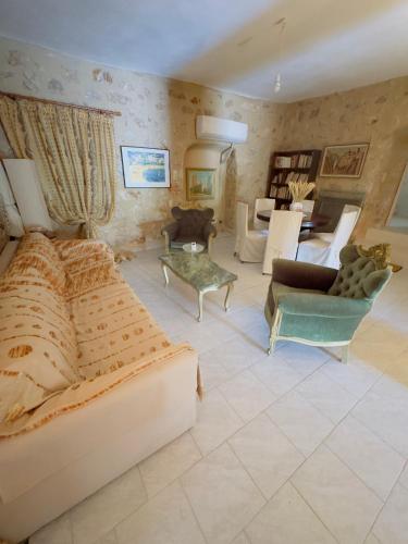 a living room with a bed and chairs and a living room at Mani Spot by the Sea in Gerolimenas
