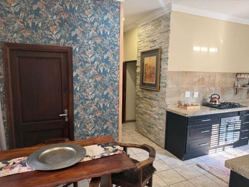 a kitchen with a table with a plate on it at Douglas Villas in Tzaneen