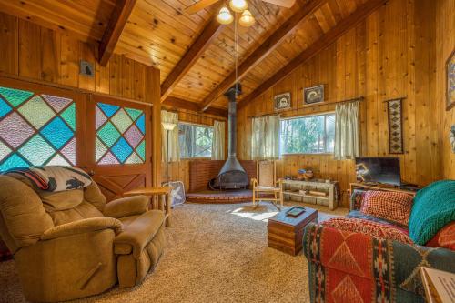 a living room with a fireplace in a log cabin at Bear's Den in Idyllwild