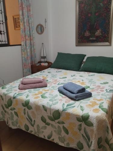 a bedroom with a bed with towels on it at Playa Velilla in Granada