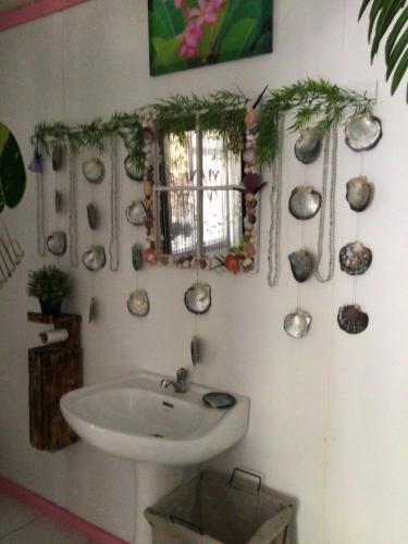 a bathroom with a white sink and a window at Tureva lodge in Tiputa