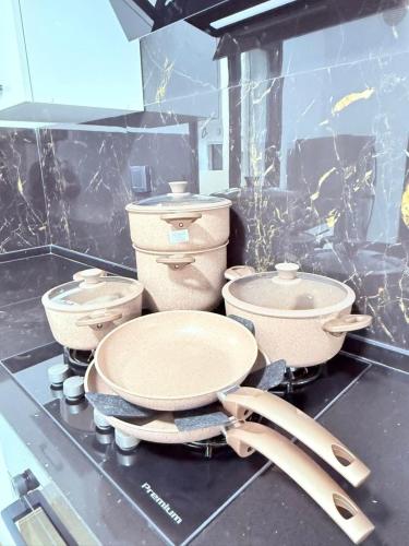 a kitchen counter with three pots and pans on it at Résidence jawhret el kram in El Aouina Station