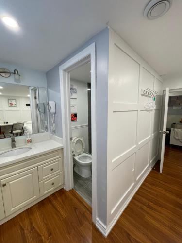 a bathroom with a white sink and a toilet at Arkona Home in Toronto