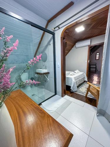 a room with a glass door leading to a bedroom at Casa Astral in Chapada dos Guimarães