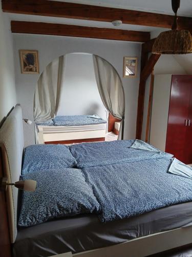 a bedroom with a bed with a mirror at Penzion Jakuby in Děčín