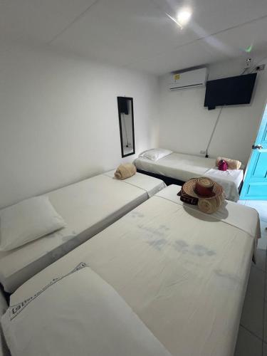 a room with two beds and a window at Guajira Sunset Hostal in Ríohacha