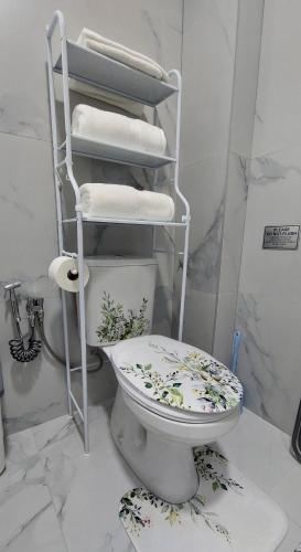 a bathroom with a toilet with towels on it at D&M Lux1 in Podgorica