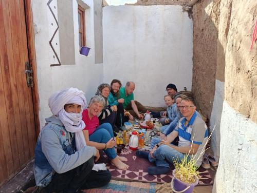 a group of people sitting around a table at Bivouac beauté du désert in Mhamid