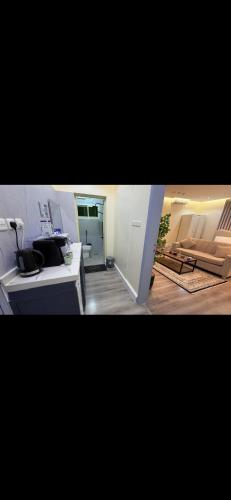 a living room with a desk and a couch at الجوهره حائل in Hail