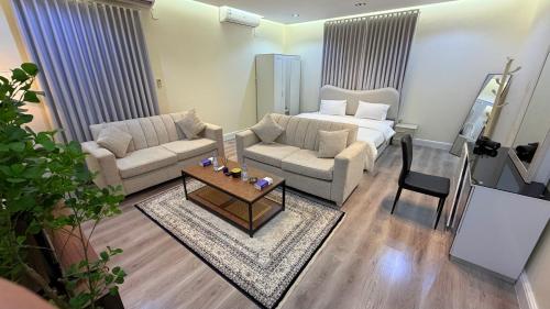a living room with a couch and a table at الجوهره حائل in Hail