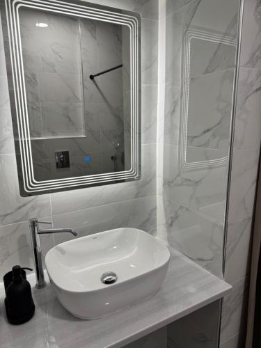 a bathroom with a white sink and a mirror at Hera in Verga Kalamata