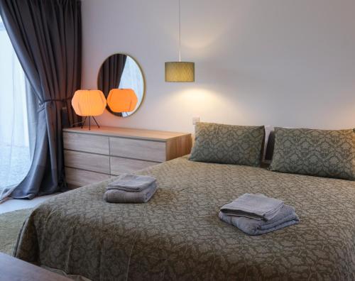 a bedroom with a bed with two towels on it at Pheasants Call in Kenmare