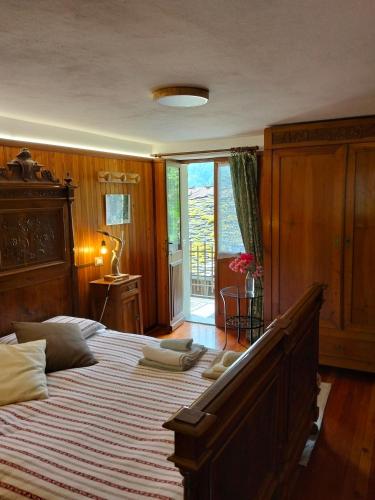 a bedroom with a large bed and a window at La baita alpina in Scopello