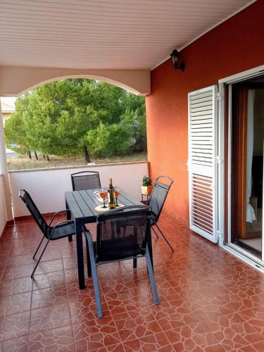a dining room with a table and chairs on a patio at Vacation Home Katarina in Nin