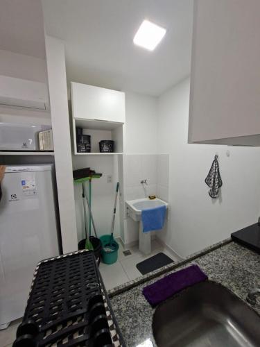 a kitchen with a sink and a counter top at Flat Itaguai in Itaguaí