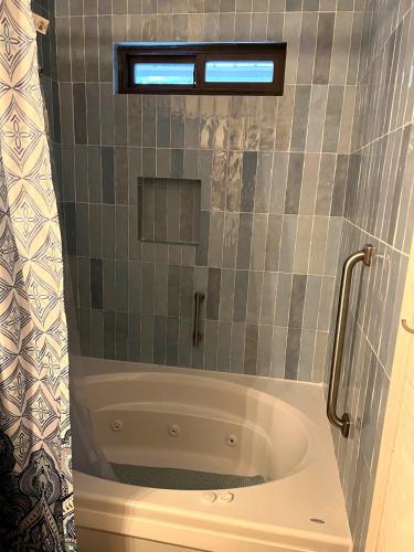 a bath tub in a bathroom with a window at Peaceful Pine Place Cabin in Pine