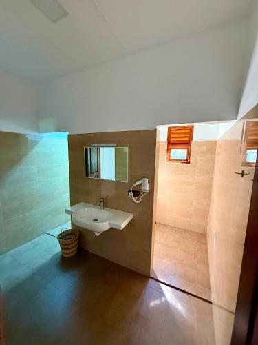a bathroom with a sink and a mirror at 108 Palms Beach Resort in Trincomalee