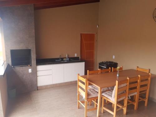 a kitchen with a wooden table and chairs in a room at quiet corner in Sao Jose do Rio Preto