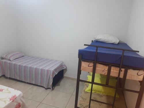 a room with a bed and a shelf with towels at quiet corner in Sao Jose do Rio Preto