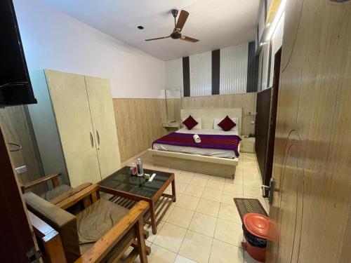 a small room with a bed and a table at Hotel shree ji in Lucknow